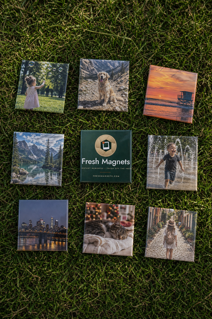 Nine 2x2 square photo magnets laid on grass around a Fresh Magnets gift box