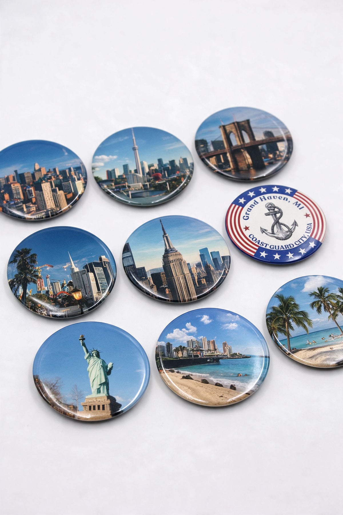 3 inch round photo magnets with city skyline photos of New York, Chicago and a beach, laid on a white table