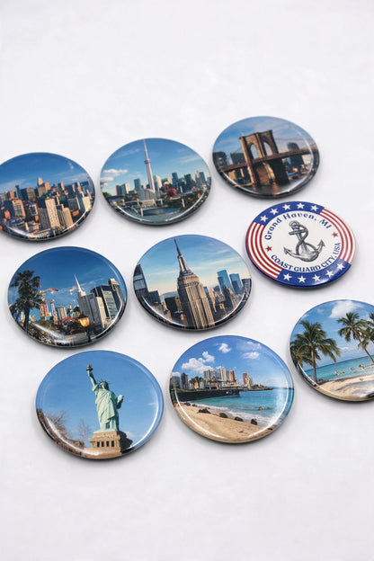 3 inch round photo magnets with city skyline photos of New York, Chicago and a beach, laid on a white table